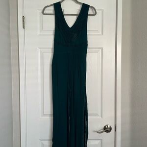 Dark turquoise green pantsuit with detailed top and side with tie in front.